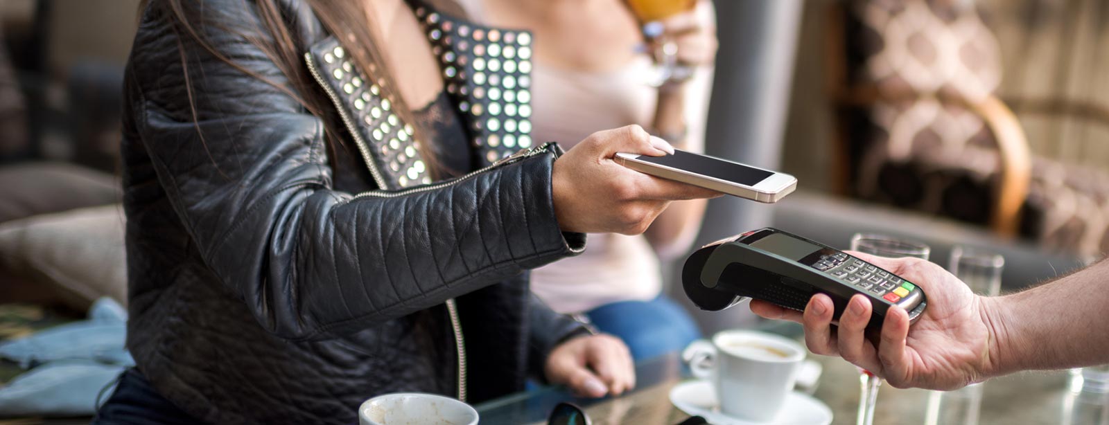 Lady paying bill with her smartphone