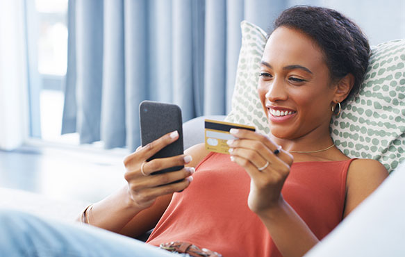 Lady using a credit card with her smartphone